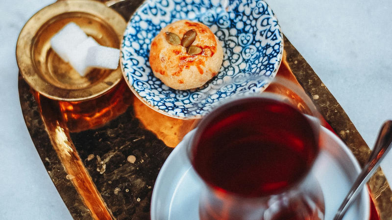 Persian saffron tea (chai-e zaferani) in a glass cup, made with Raihan Afghan Super Negin saffron